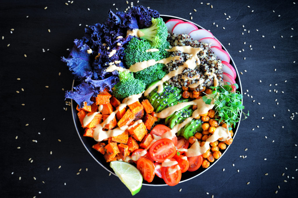 Vegan Buddha bowl with quinoa, baked sweet potato and red kale leaves