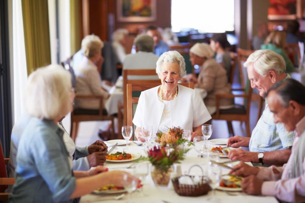 A group of elderly people having lunch together at a nursing home