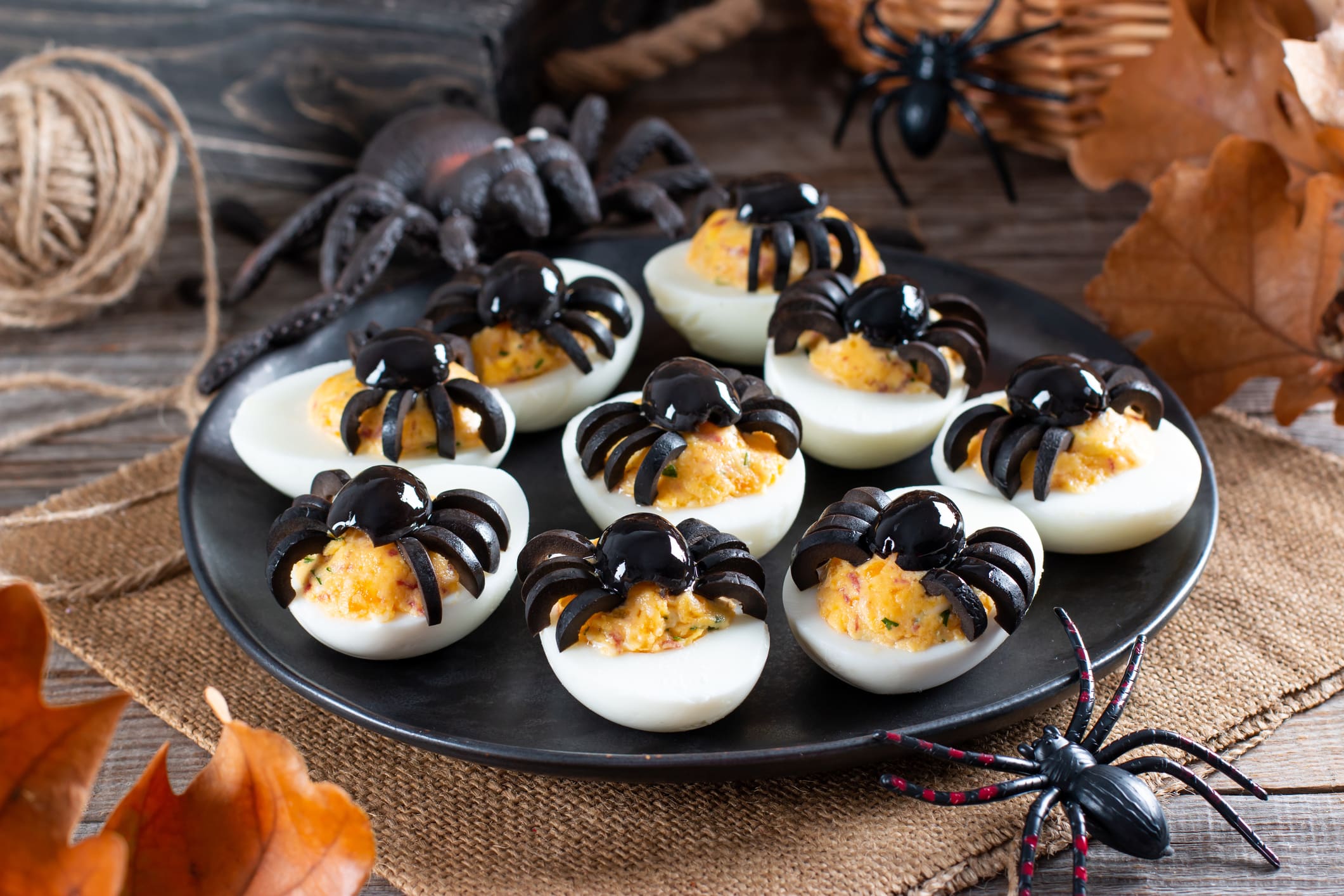 The idea for decorating a table for Halloween: stuffed eggs with spiders from olives