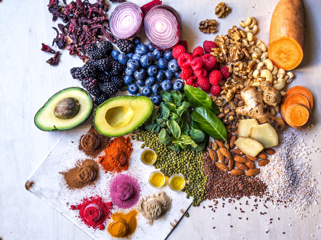 Anti-inflammatory vegetables, fruits, legumes, nuts and spices relieving health problems - vegetables, fruits, legumes, nuts and spices for health benefits on wooden table - healthy eating, superfood, copy space